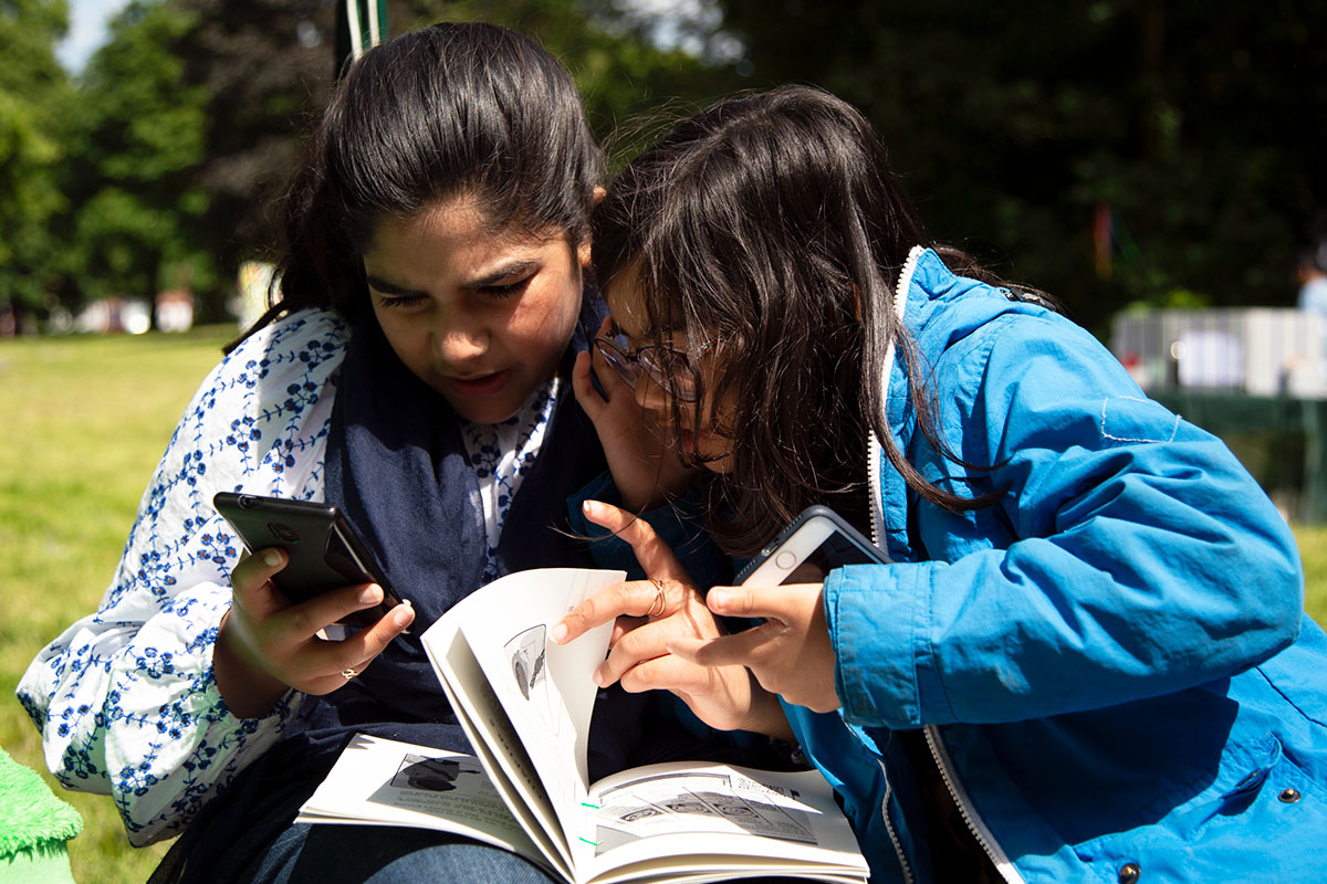 Two girls are playing the book together